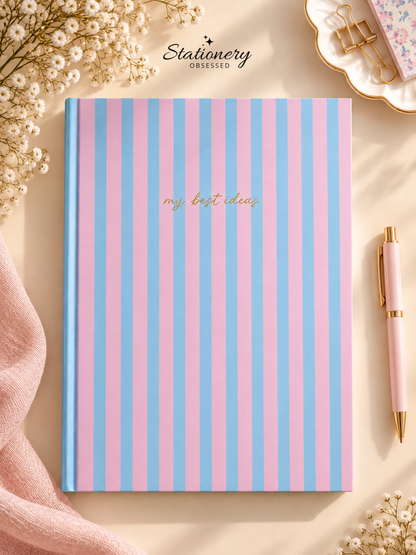 A4 pink and blue striped hardback lined notebook with ‘my best ideas’ script on the cover.